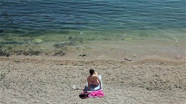 Attractive Woman Sunbathing On Beach, Balaklava, Criema, Ukraine