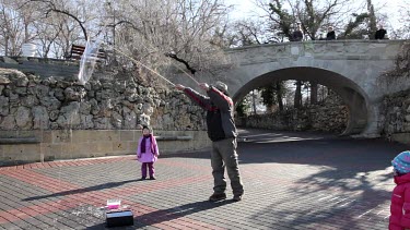 Man Creates Childrens Bubbles With Rods & Washing Up Liquid, Sevastopol, Crimea, Ukraine