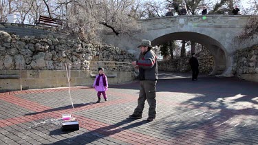 Man Creates Childrens Bubbles With Rods & Washing Up Liquid, Sevastopol, Crimea, Ukraine