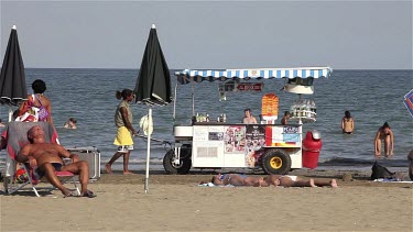 Man Moving Drinks Trolly On Beach, Lido, Venice, Italy