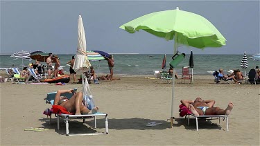 Sunbathers On Beach In Wind, Lido, Venice, Italy
