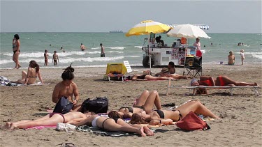 Women Sunbathing On Beach, Lido, Venice, Italy