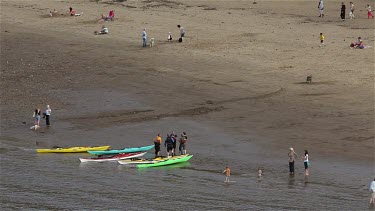 Canoes & People On East Cliff Beach, Whitby, North Yorkshire, England