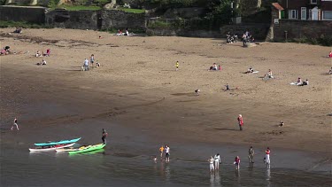Canoes & People On East Cliff Beach, Whitby, North Yorkshire, England