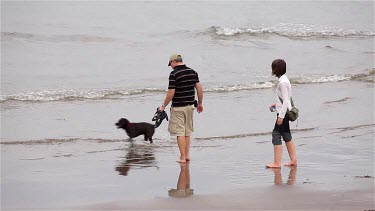 Girl & Man With Dog In Sea, Sandsend, North Yorkshire, England