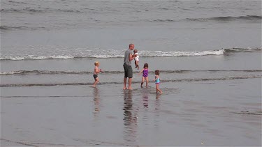 Children Playing In The Sea, Sandsend, North Yorkshire, England