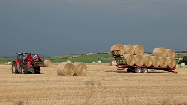 Red Tractor Loads Trailer With Straw, A174, North Yorkshire, England