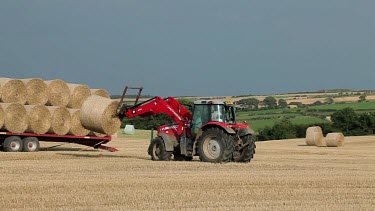 Red Tractor Loads Trailer With Straw, A174, North Yorkshire, England