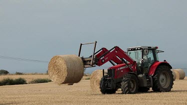 Red Tractor Collects Straw Bales, A174, North Yorkshire, England