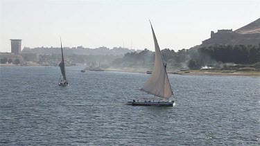 Felucca In Full Sail & Tombs Of The Nobles, Aswan, Egypt