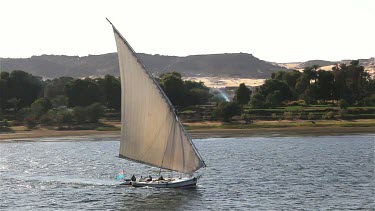 Felucca In Full Sail Along West Bank, Aswan, Egypt