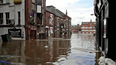 Wheelie Bin And Other Debris Float Down The Street, City Of York, England