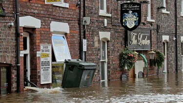 Wheelie Bin And Other Debris Float Past The Lowther Pub, City Of York, England