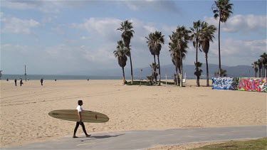 Surfer Carrying Surfboard On Cycle Path, Venice Boardwalk, Venice Beach, Venice, California, Usa