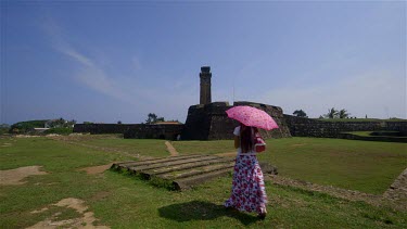 Lady, Pink Parasol & Clock Tower, Galle Forte, Sri Lanka