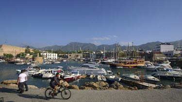 Cyclist On Quay & Boats In Harbour, Kyrenia, Northern Cyprus