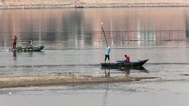 Fishermen On Rowing Boats Putting Out Nets, River Nile, Luxor, Egypt